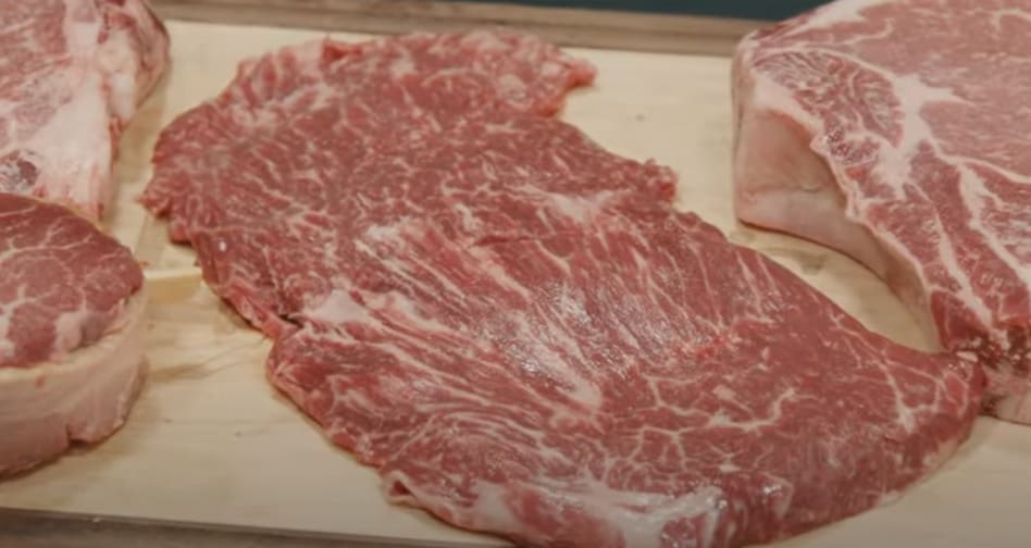 guide to buying beef shot of a cut of beef on a professional slab from frank's