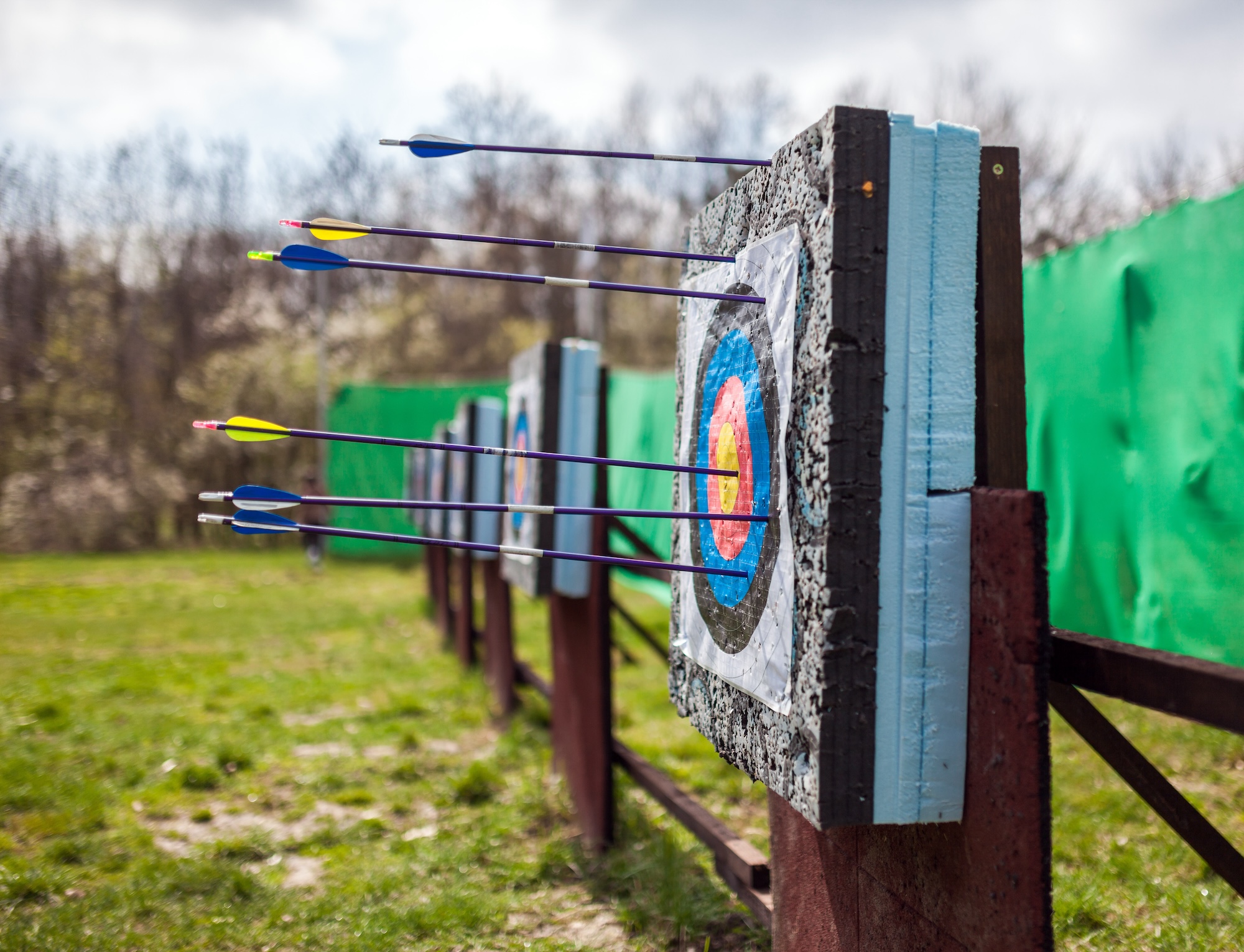 Targets at a bow shooting range with arrows in them