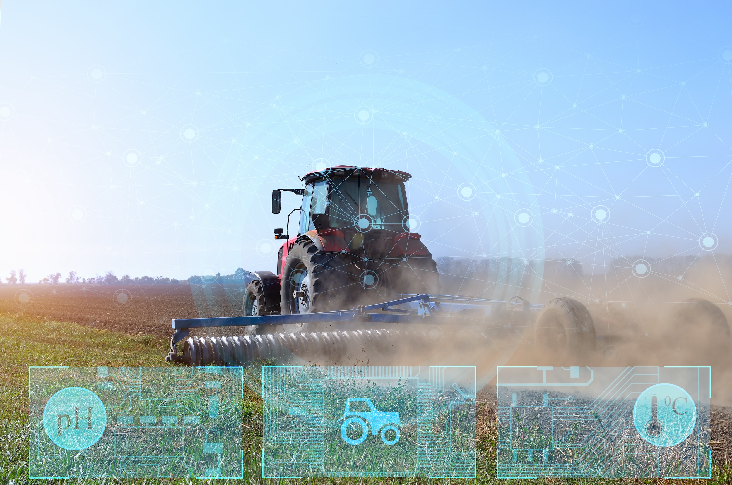autonomous driverless tractor with smart technologies connectivity driving through an open farm field