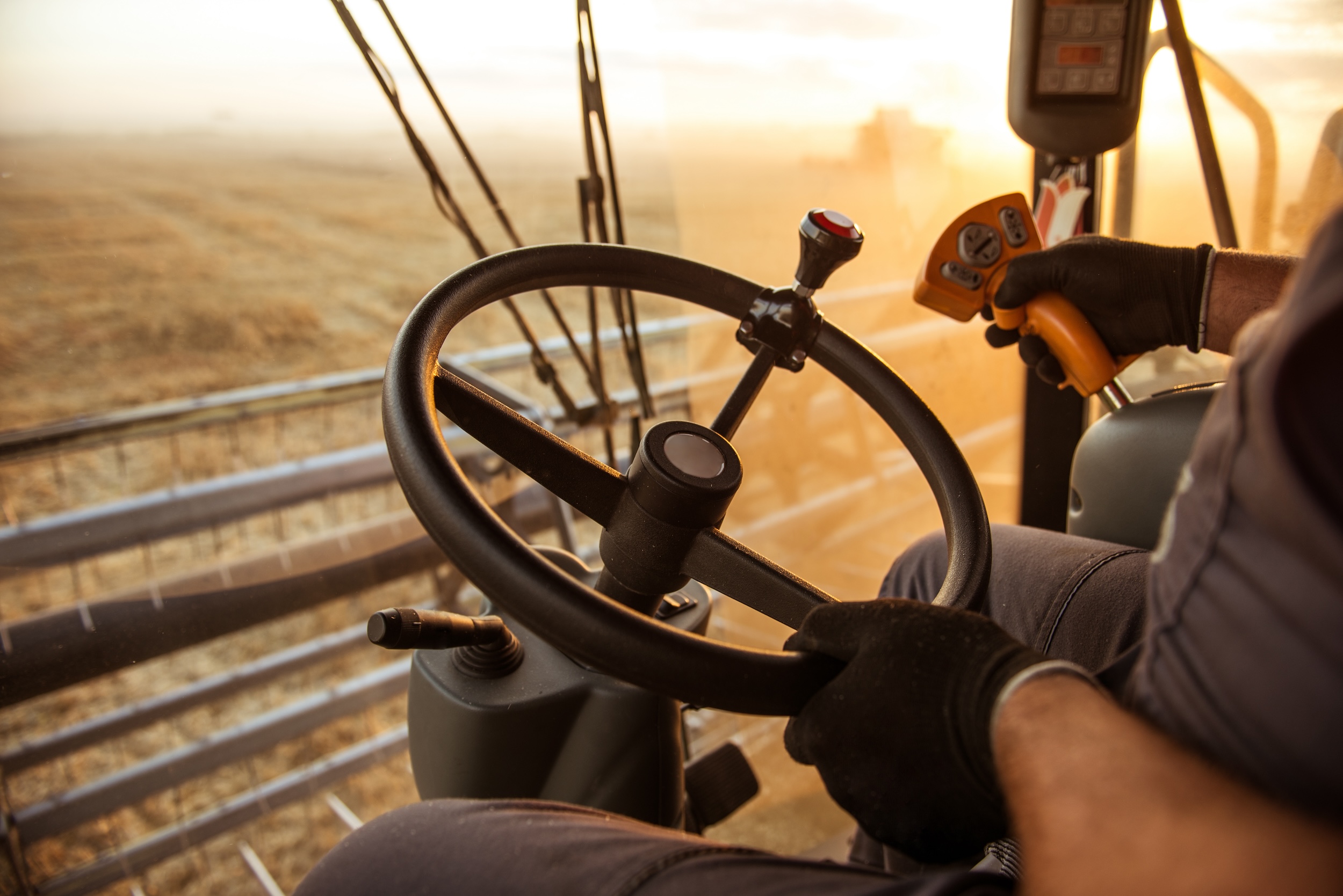 hand holding a steering wheel