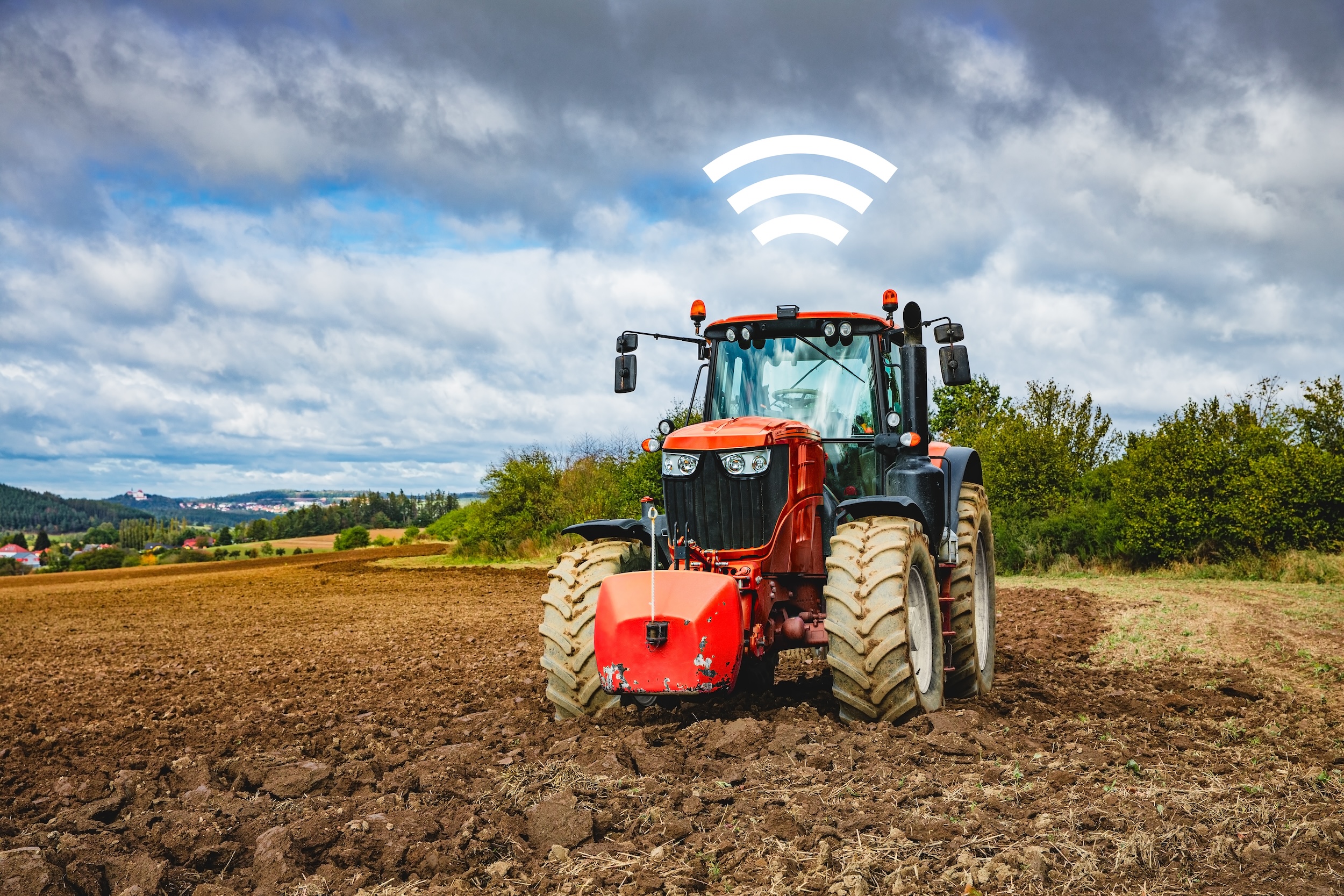 self driving tractor with the wifi symbol hovering above it
