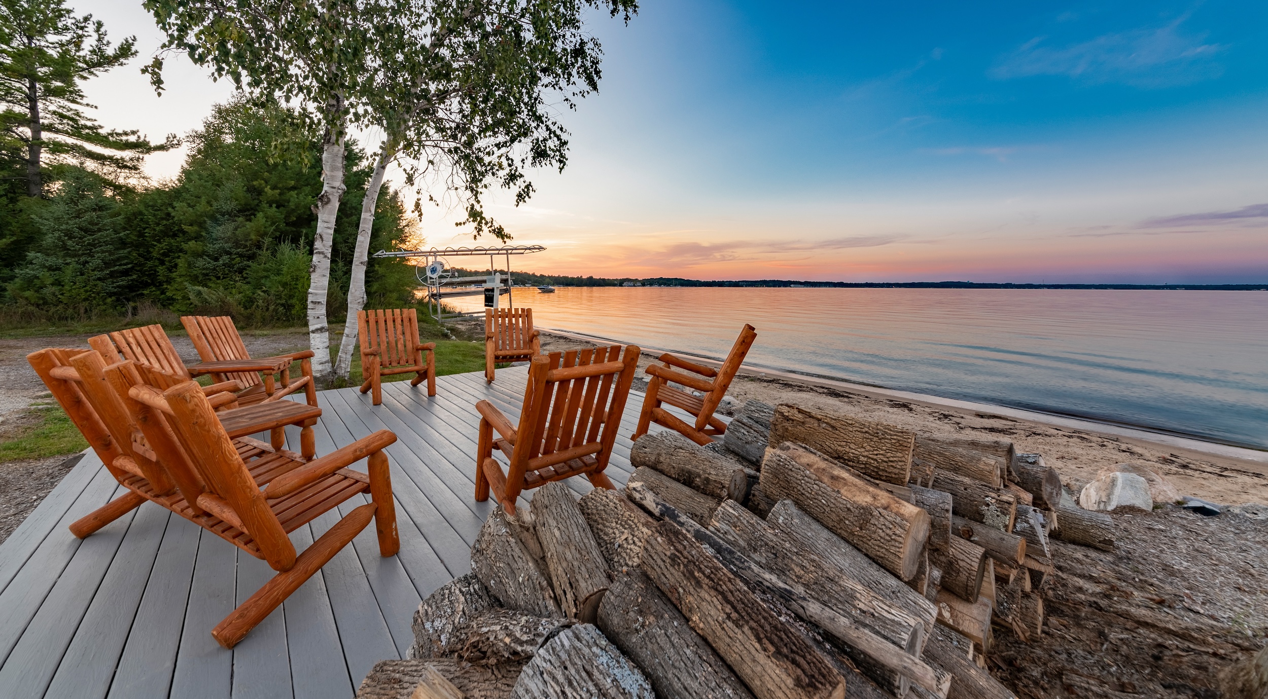 chairs sitting on a patio by a lake