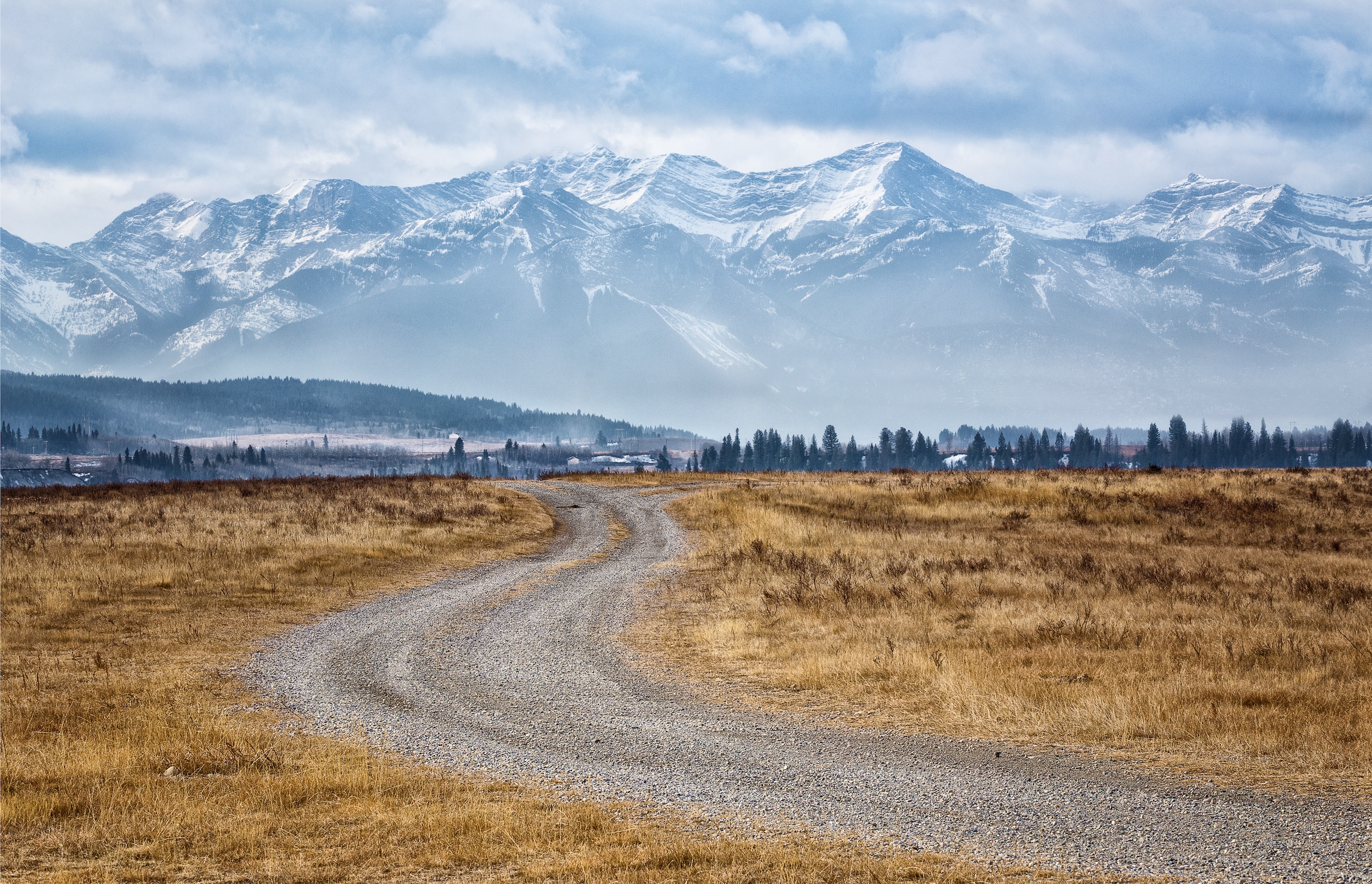 rural dirt road meandering through the land of a mountain investment property