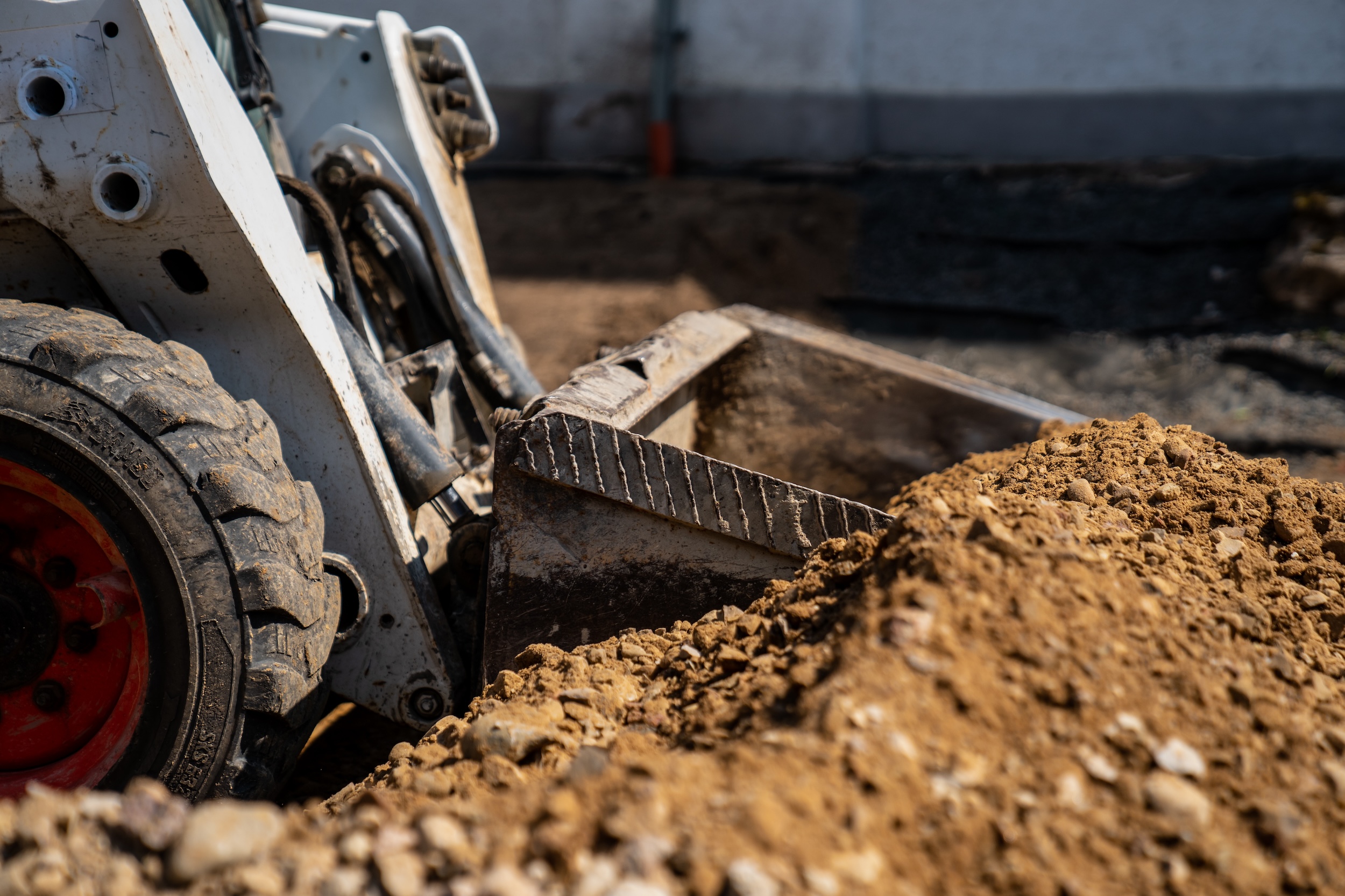 close up of a piece of excavation equipment scooping up dirt