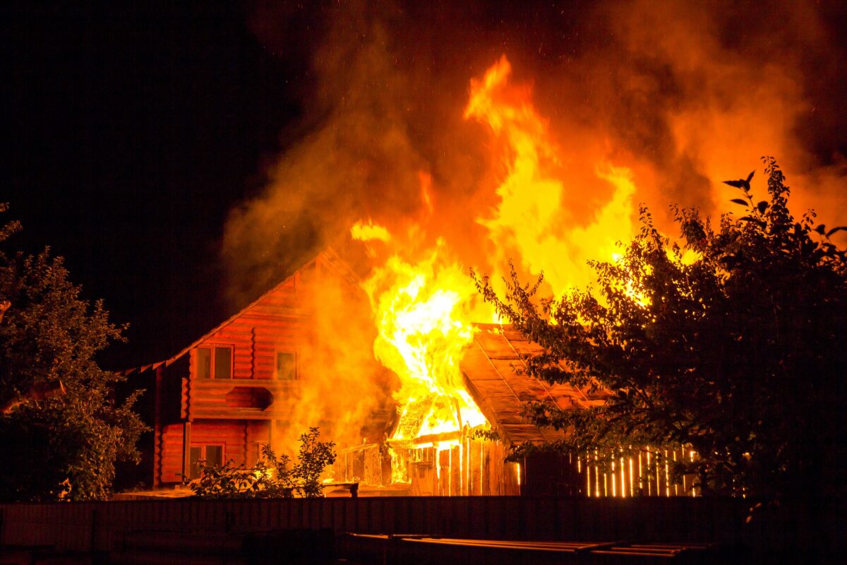 home that didn't incorporate a wildfire mitigation plan engulfed in flames from a raging fire