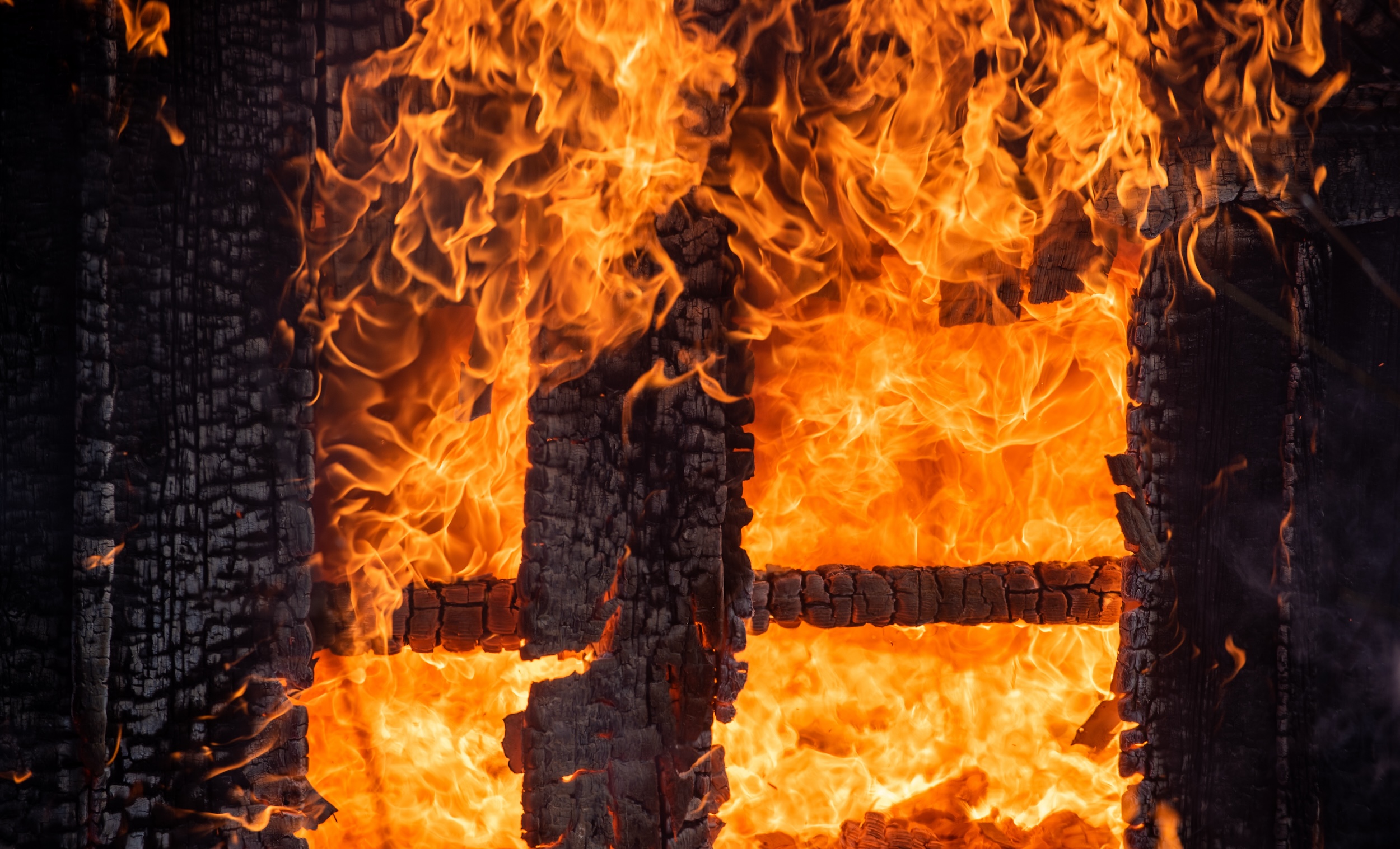 wooden fence burning in a wildfire