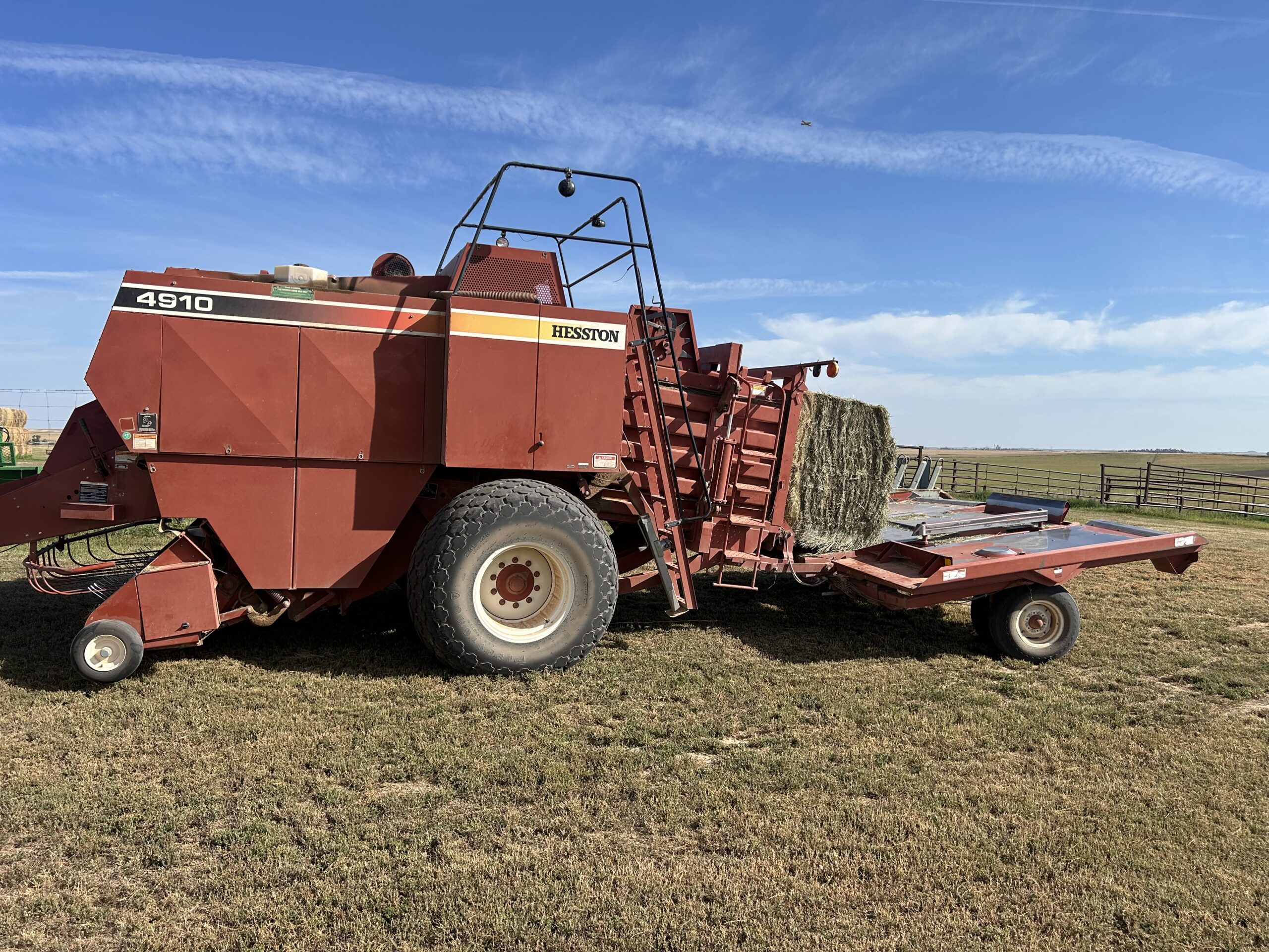 Thumbnail image of a Hesston 4910 4X4 Large Square Baler with Accumulator