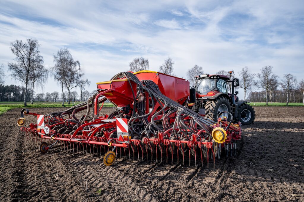 seeding drill no till farming equipment navigating a patch of soil