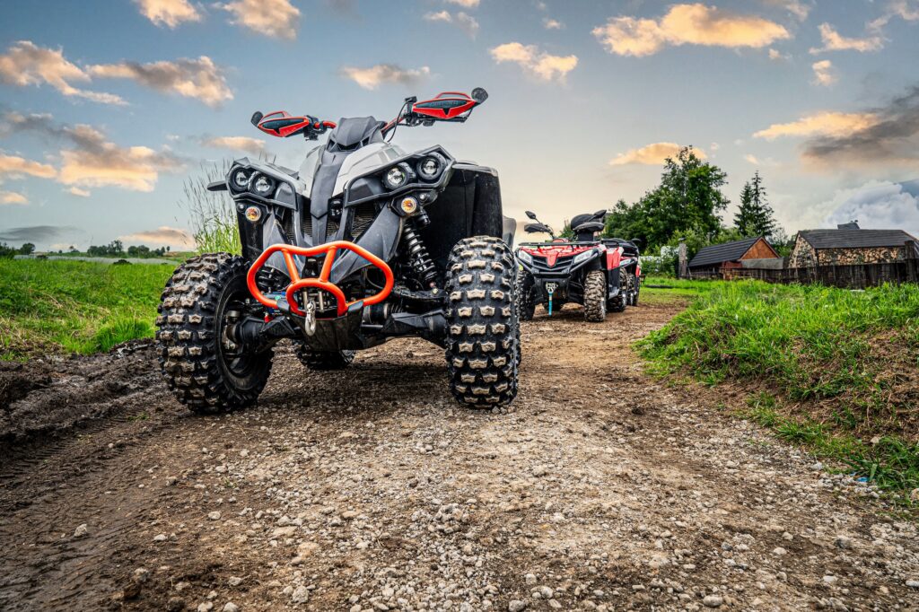 atv quads lined up on a dirt road