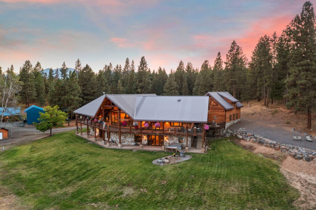 lodge style ranch home on wooded land being sold by a good Hayden Outdoors real estate agent