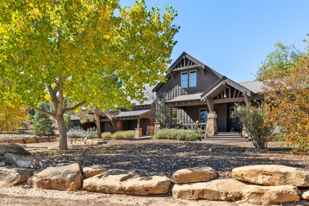 craftsman style mountain home in Colorado with trees in the front yard selling via a good Hayden Outdoors real estate agent