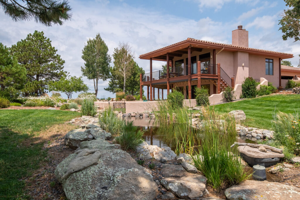 Spanish style multi story home with a terracotta tile roof and large patio