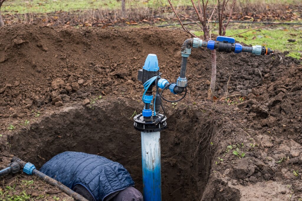 worker drilling for a water well