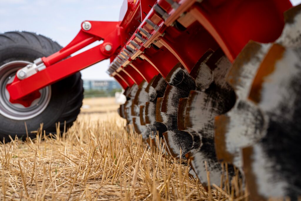 disc harrow blades going over the ground on a wheat field