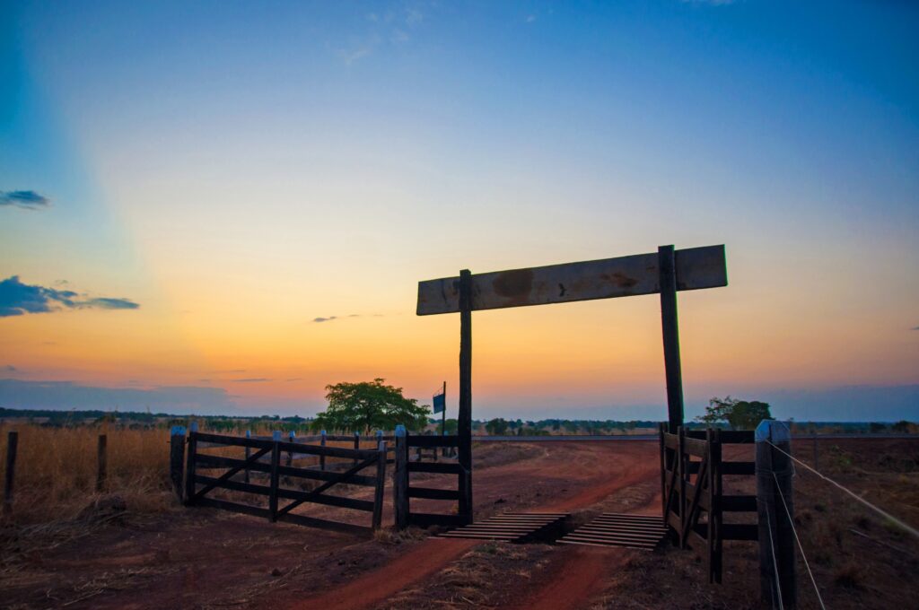 entrance to a ranch with a cattle guard grate installed on the ground